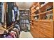 Walk-in closet with custom built in shelving and hanging rods for ample storage at 2248 Fort Se Dr, Smyrna, GA 30080