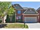 Charming two-story brick home with a manicured lawn and two-car garage on a sunny day at 2248 Fort Se Dr, Smyrna, GA 30080