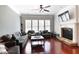 Bright living room featuring hardwood floors, a fireplace, and large windows at 2248 Fort Se Dr, Smyrna, GA 30080
