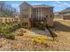 The rear of the home shows an entertainment deck, walkout basement and fenced-in backyard at 2470 Bridle Bridge Trl, Cumming, GA 30040