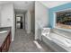 This primary bathroom features a soaking tub, walk-in shower, and double vanity at 2470 Bridle Bridge Trl, Cumming, GA 30040