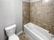 A modern tub and ceramic tile wall are focal points in this clean bathroom at 2470 Bridle Bridge Trl, Cumming, GA 30040