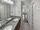 This bathroom features double sinks, granite countertops, and modern fixtures at 2470 Bridle Bridge Trl, Cumming, GA 30040