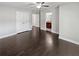 Spacious bedroom features a ceiling fan and closet with dark hardwood flooring at 2470 Bridle Bridge Trl, Cumming, GA 30040