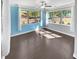 This bedroom features hard wood flooring, two large windows, and bright accent colors at 2470 Bridle Bridge Trl, Cumming, GA 30040