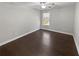 Bedroom with hardwood floors, baseboard trim and a window for natural light at 2470 Bridle Bridge Trl, Cumming, GA 30040