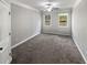 This bedroom features neutral paint, plush gray carpeting, two windows, and a ceiling fan at 2470 Bridle Bridge Trl, Cumming, GA 30040