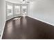 Large bedroom featuring plenty of windows for natural light, ceiling fan, and hardwood floors at 2470 Bridle Bridge Trl, Cumming, GA 30040