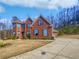 Charming two-story brick home with a well-manicured lawn and inviting curb appeal at 2470 Bridle Bridge Trl, Cumming, GA 30040