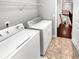 Convenient laundry room with washer, dryer, and shelf, located near stairway at 2470 Bridle Bridge Trl, Cumming, GA 30040