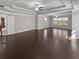 This expansive living room features hardwood floors, tray ceilings, and recessed lighting at 2470 Bridle Bridge Trl, Cumming, GA 30040