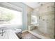 Modern bathroom featuring soaking tub and a large glass-enclosed shower with a built-in bench at 2634 Charlesgate Ave, Decatur, GA 30030