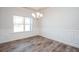 Dining room with custom wainscoting, wood floors, and modern chandelier at 267 Eason St, Bowdon, GA 30108