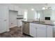 Open floor plan featuring island, granite countertops and stainless steel dishwasher at 267 Eason St, Bowdon, GA 30108