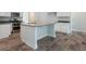 White kitchen island with granite countertops and stainless steel appliances at 267 Eason St, Bowdon, GA 30108