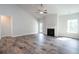 Spacious living room with wood flooring, a fireplace, and natural light, perfect for gatherings and relaxation at 267 Eason St, Bowdon, GA 30108