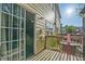 Back patio with sliding glass doors and a green metal table set at 384 Parc River Blvd, Lawrenceville, GA 30046