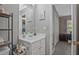 Bright bathroom features a single vanity, large mirror, shelving and is adjacent to bedroom at 384 Parc River Blvd, Lawrenceville, GA 30046
