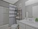 This bathroom features a shower/tub combo and a single sink vanity with shelving at 384 Parc River Blvd, Lawrenceville, GA 30046