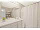 Bathroom with white vanity, large mirror, and a shower with a curtain at 384 Parc River Blvd, Lawrenceville, GA 30046