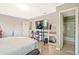 Modern bedroom with laminate floors, large mirror, and an ensuite bathroom at 384 Parc River Blvd, Lawrenceville, GA 30046