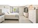Spacious bedroom with a white dresser, bedside table, and natural light at 384 Parc River Blvd, Lawrenceville, GA 30046