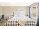 Cozy bedroom with a large window and a plush plaid comforter at 384 Parc River Blvd, Lawrenceville, GA 30046