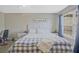 This bedroom features a large window for natural lighting, gray walls, and vinyl flooring at 384 Parc River Blvd, Lawrenceville, GA 30046