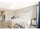 Well-lit bedroom with a white dresser, modern decor, and a window view at 384 Parc River Blvd, Lawrenceville, GA 30046