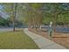The dog park features a convenient waste station and a paved walkway lined with trees at 384 Parc River Blvd, Lawrenceville, GA 30046
