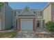 Townhome exterior with manicured lawn and attached garages at 384 Parc River Blvd, Lawrenceville, GA 30046