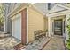 Inviting townhome featuring a front porch with a bench and a single car garage at 384 Parc River Blvd, Lawrenceville, GA 30046