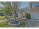 Inviting townhome boasts a one-car garage, well-maintained lawn, and landscaped tree bed at 384 Parc River Blvd, Lawrenceville, GA 30046