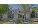 Charming townhome featuring a one-car garage, manicured lawn, and welcoming entrance at 384 Parc River Blvd, Lawrenceville, GA 30046
