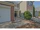 Townhome exterior featuring a sidewalk leading to front door and an attached garage at 384 Parc River Blvd, Lawrenceville, GA 30046