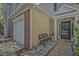 Townhome with a sidewalk leading to front door and a cozy bench at 384 Parc River Blvd, Lawrenceville, GA 30046