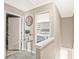 Upstairs hallway with view into bedroom that has natural light, and neutral paint colors at 384 Parc River Blvd, Lawrenceville, GA 30046