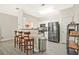 Open kitchen with stainless steel appliances, breakfast bar with seating, and hardwood floors at 384 Parc River Blvd, Lawrenceville, GA 30046