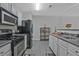 Well-lit kitchen featuring stainless steel appliances and ample counter space at 384 Parc River Blvd, Lawrenceville, GA 30046
