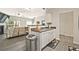 Open concept kitchen featuring ample counter space, white cabinetry, and hardwood floors at 384 Parc River Blvd, Lawrenceville, GA 30046