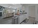 Open concept kitchen view into living room with modern features and stainless steel appliances at 384 Parc River Blvd, Lawrenceville, GA 30046