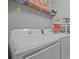 Functional laundry room with washer, dryer and storage shelves for supplies at 384 Parc River Blvd, Lawrenceville, GA 30046