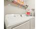 Laundry room featuring a washing machine, dryer, and shelving for storage and essentials at 384 Parc River Blvd, Lawrenceville, GA 30046