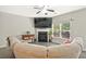 Cozy living room featuring a fireplace, large TV, and comfortable seating arrangement at 384 Parc River Blvd, Lawrenceville, GA 30046