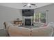 Cozy living room with fireplace, large screen television and natural light at 384 Parc River Blvd, Lawrenceville, GA 30046