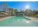 Large community pool featuring a large swimming area, lounge chairs, and a clubhouse in the background at 384 Parc River Blvd, Lawrenceville, GA 30046