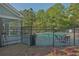 Community pool area featuring an iron fence, seating, and well-maintained landscaping at 384 Parc River Blvd, Lawrenceville, GA 30046