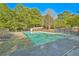 Large community swimming pool surrounded by lounge chairs and tables in a secure fenced area at 384 Parc River Blvd, Lawrenceville, GA 30046