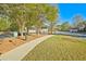 Residential street featuring sidewalk, well-kept lawns, street parking and pet waste station for community convenience at 384 Parc River Blvd, Lawrenceville, GA 30046