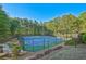 Well-maintained community tennis courts surrounded by mature trees on a clear day at 384 Parc River Blvd, Lawrenceville, GA 30046